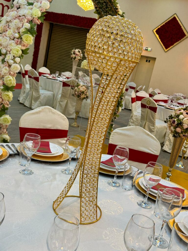 Crystal and gold centerpiece on a decorated banquet table at Baab-e-Salaam wedding hall